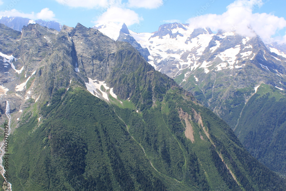mountain peaks of elbrus region in dombai in midsummer