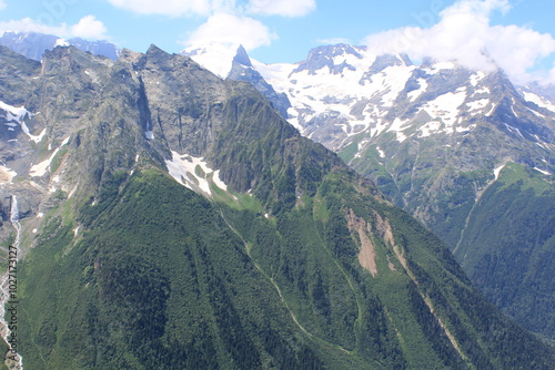 mountain peaks of elbrus region in dombai in midsummer photo