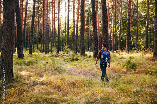 Rear view of man walking through the forest during autumn hike