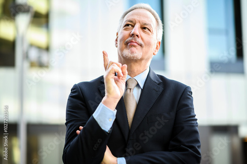 Mature businessman in a suit having a moment of inspiration outd photo