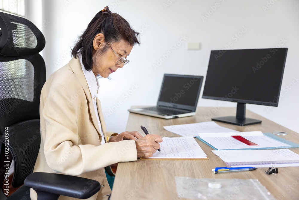 Senior asian businesswoman is working on analyzing information and data in the formal office for education, business, lawyer and accountant Senior asian businesswoman is working on analyzing information and data in the formal office for education, business, lawyer and accountant