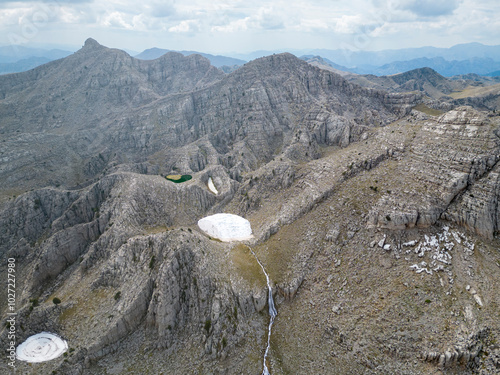 Snow masses, waterfalls and magnificent texture on the peaks of the mountains photo