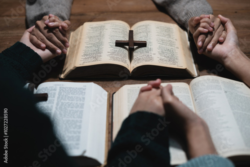 Closeup of simple wooden Christian cross on Bible. Concept of hope, faith, christianity, religion.