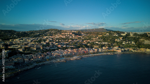 A stunning aerial shot of Pozzuoli, highlighting its scenic coastline and vibrant harbor.The drone captures the ancient Roman ruins, the calm sea, and the natural beauty surrounding the historic city.