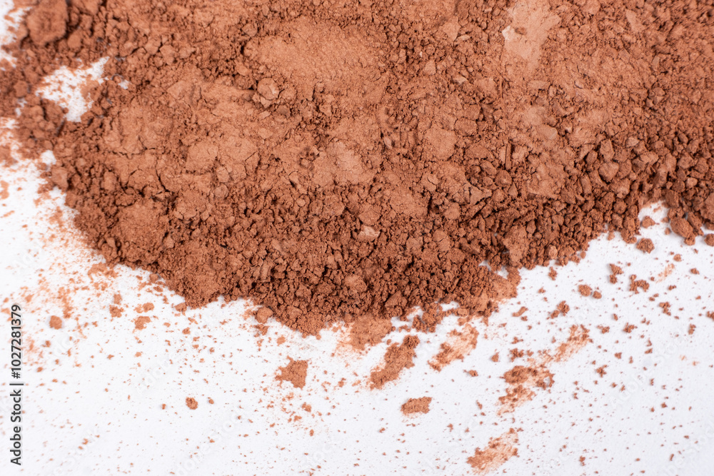 Scattered brown eyeshadow on a white background. Eye shadow texture Scattered brown eyeshadow on a white background. Eye shadow texture