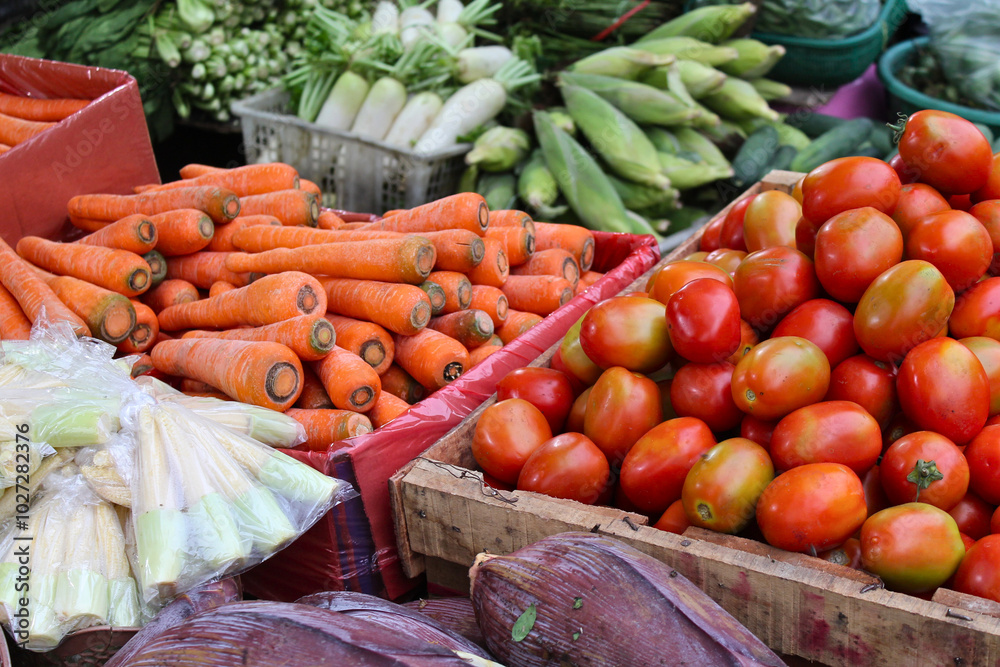 Closeup view of basket filled with tomatoes, carrots, radishes and corn at fresh market. Closeup view of basket filled with tomatoes, carrots, radishes and corn at fresh market.