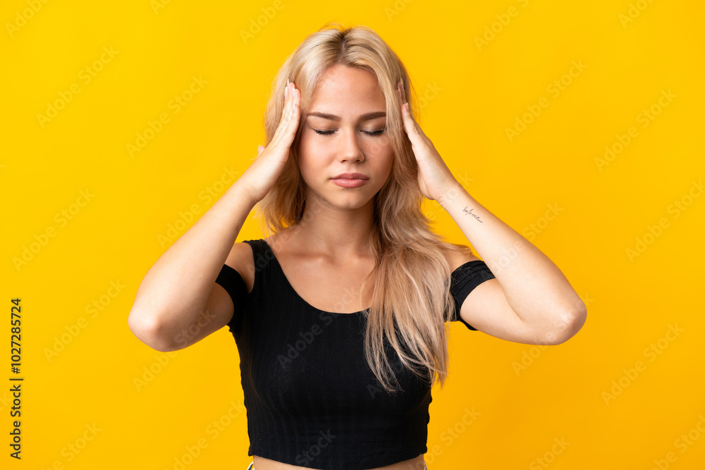 Fototapeta premium Young Russian woman isolated on yellow background with headache