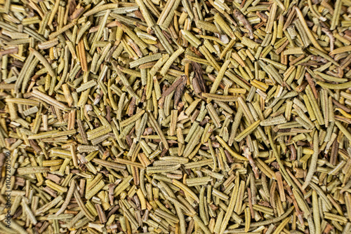 Background macro dried rosemary leaves top view, seasoning texture.