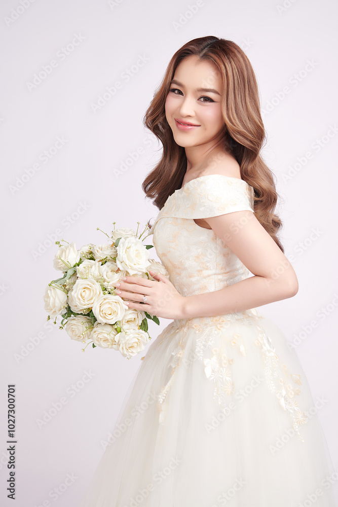 Beautiful young asian woman in wedding dress holding bouquet on white background, Beautiful young asian woman in wedding dress holding bouquet on white background,