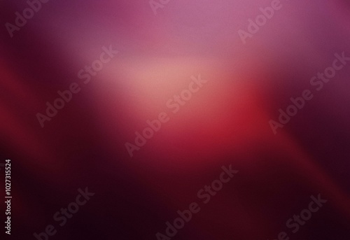 Abstract grainy burgundy background with a gradient of light to dark.