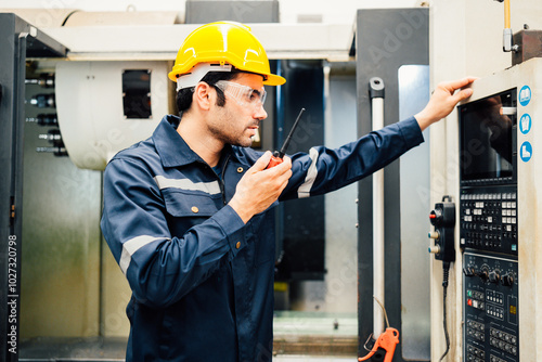 Professional Engineering of modern factory checking  to automatic machinery. Engineering with clipboard Programmable Logic Controller to manage large machine working full automatic.