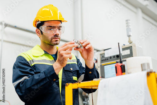 Professional Engineering of modern factory checking  to automatic machinery. Engineering with clipboard Programmable Logic Controller to manage large machine working full automatic.