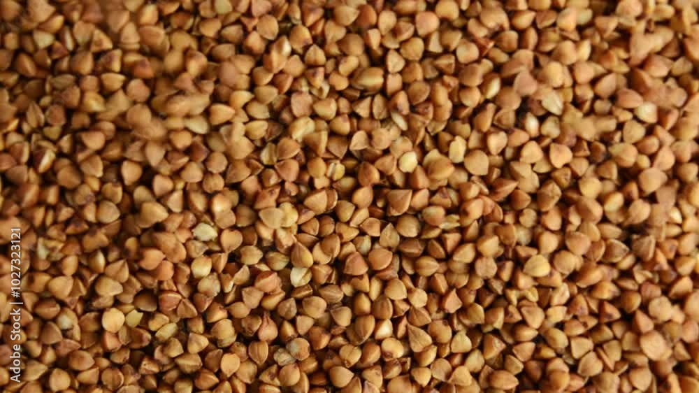 Buckwheat porridge rotates, top view. Slow rotation. Porridge is poured on top. Buckwheat porridge rotates, top view. Slow rotation. Porridge is poured on top.