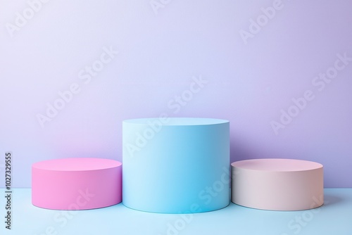 Colorful round pedestals in pink, blue, and beige against a pastel backdrop, perfect for showcasing products or art.