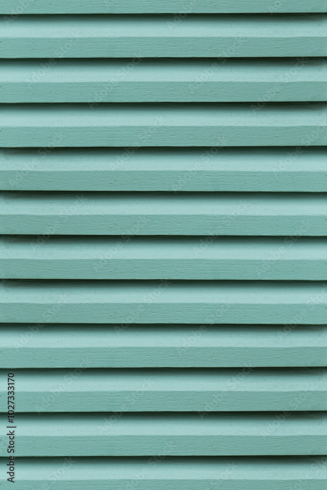 The close-up of the green wooden vent lattice; highlights its intricate design, providing a vibrant background. The close-up of the green wooden vent lattice; highlights its intricate design, providing a vibrant background.