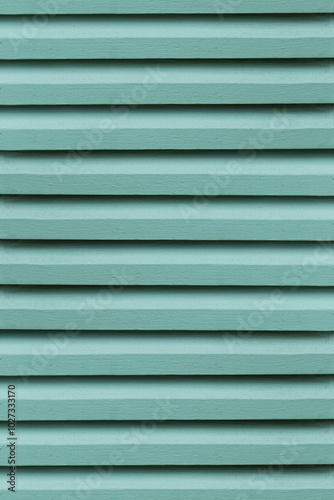 The close-up of the green wooden vent lattice; highlights its intricate design, providing a vibrant background.