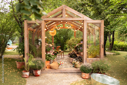 Wallpaper Mural Interior of a wooden illuminated greenhouse with furniture, plants and flowers in pots at backyard. Home gardening. Cozy garden with glass vintage glass greenhouse with chair. Exterior glasshouse Torontodigital.ca