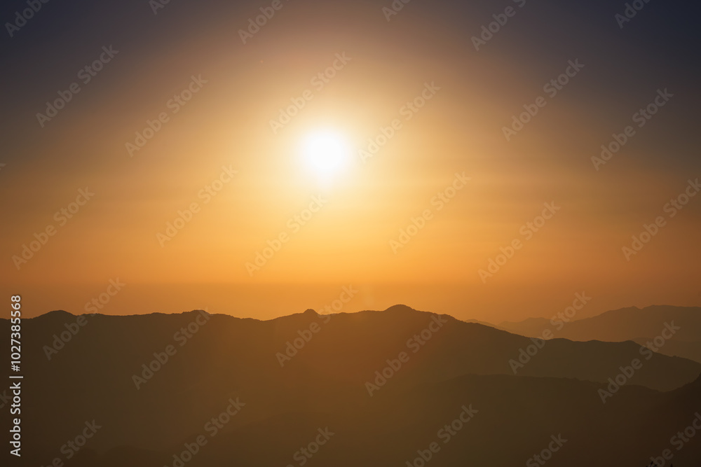 Sunlight is dispersed in the atmosphere. At sunset, the sky becomes yellow or gold. The mountains look like an oriental painting. Sunlight is dispersed in the atmosphere. At sunset, the sky becomes yellow or gold. The mountains look like an oriental painting.