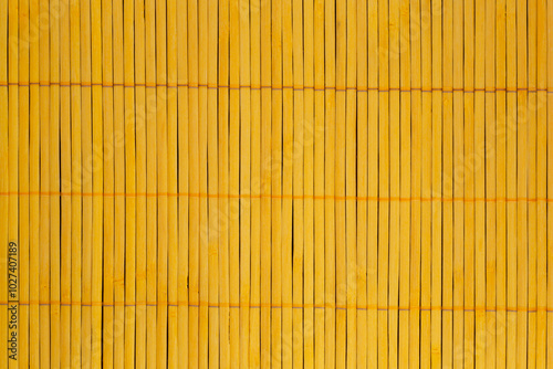 close up of yellow mat made of bamboo sticks photo