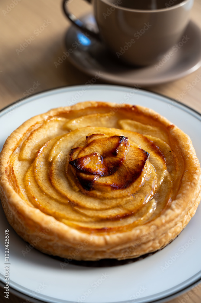 French fresh baked sweet puff pastry with fresh apple fruits in sirup in confectionery shop French fresh baked sweet puff pastry with fresh apple fruits in sirup in confectionery shop