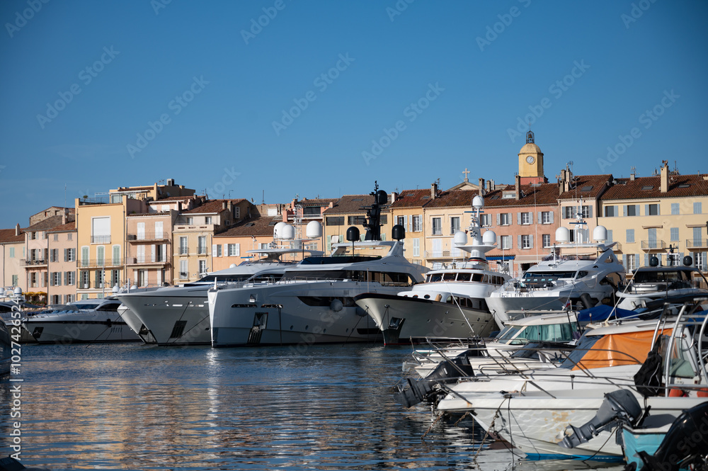 Old port of Saint-Tropez famous touristic village on French Riviera, summer vacation with large yacht boats and colorful houses Old port of Saint-Tropez famous touristic village on French Riviera, summer vacation with large yacht boats and colorful houses