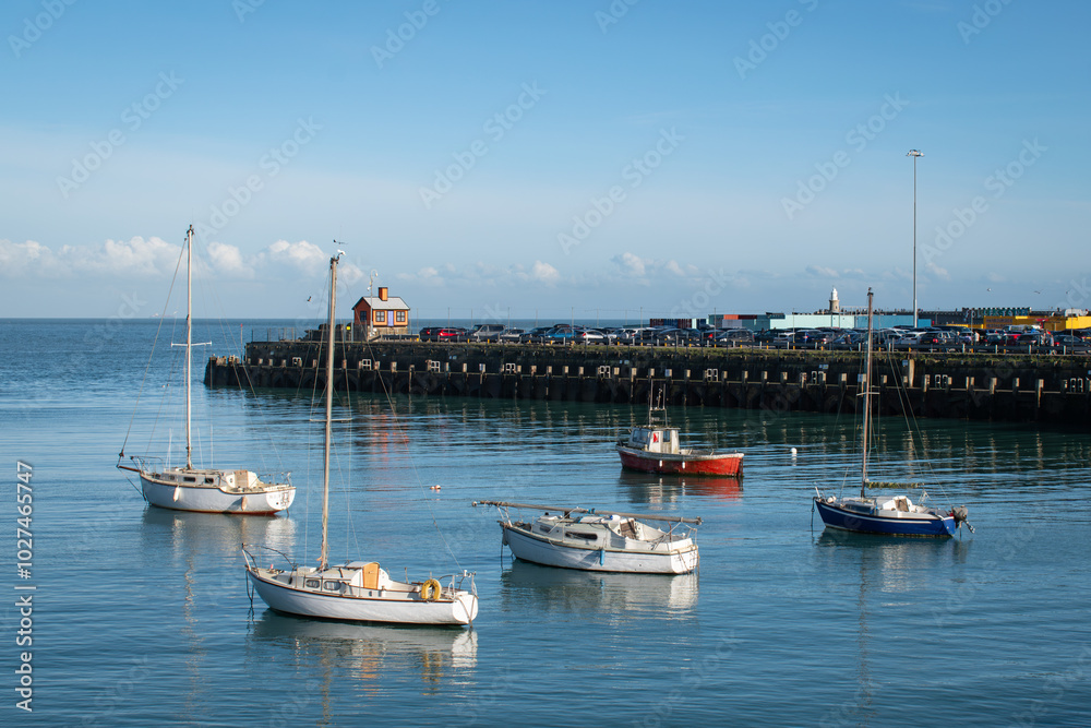 Fototapeta premium Boats in harbour blue sky peaceful blue turquoise sea 