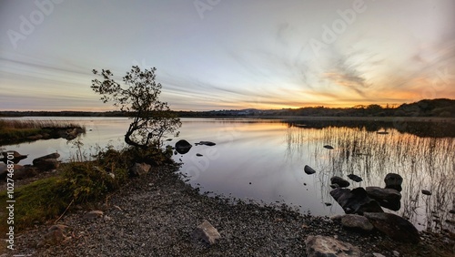 Obraz na płótnie Beautiful orange sunset lakeside landscape scenery at Ballyquirke lough, Galway, Ireland, nature background w salonie