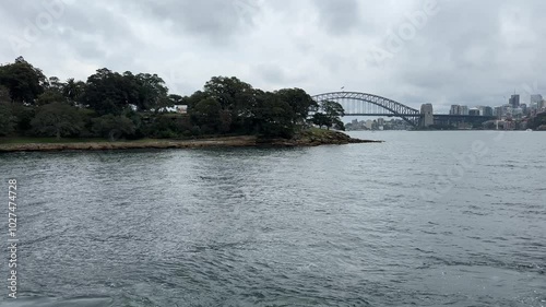 Sydney Opera House & Harbour Bridge revealed from behind a headland