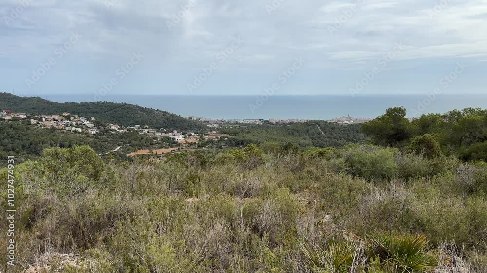 Exploring the scenic coastal view from the hills near a seaside town on a cloudy afternoon Exploring the scenic coastal view from the hills near a seaside town on a cloudy afternoon