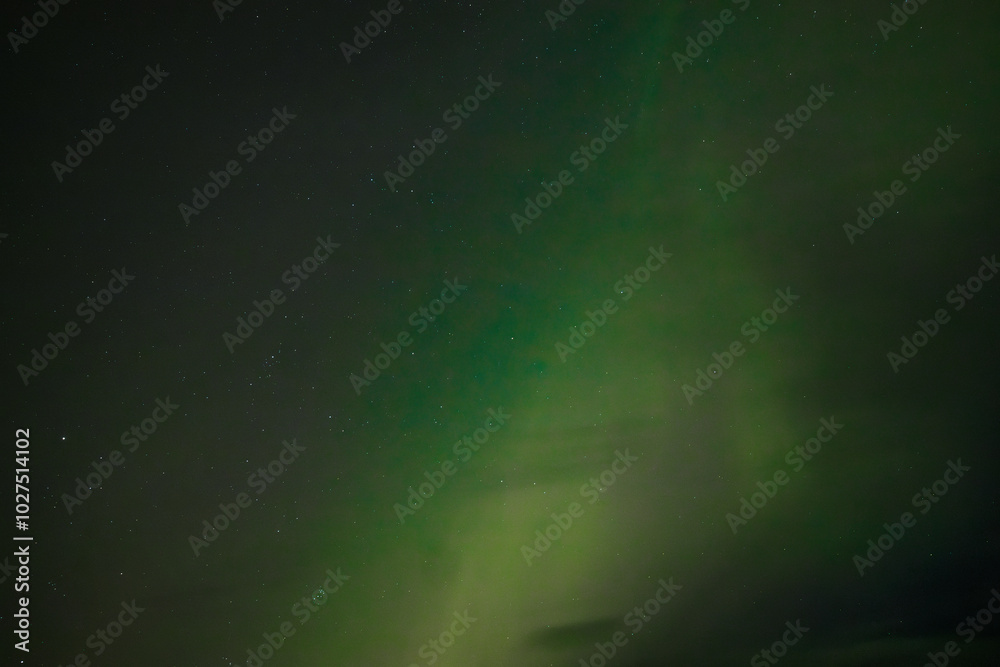 A peaceful display of the Aurora Borealis casts soft green light across the starry night sky. The gentle glow blends into the dark background, creating a serene and ethereal atmosphere. A peaceful display of the Aurora Borealis casts soft green light across the starry night sky. The gentle glow blends into the dark background, creating a serene and ethereal atmosphere.
