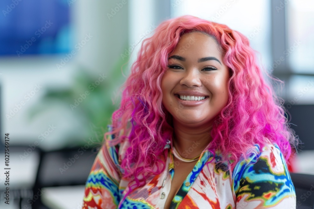 Close-up portrait of a smiling young woman with pink hair in a bright office Close-up portrait of a smiling young woman with pink hair in a bright office