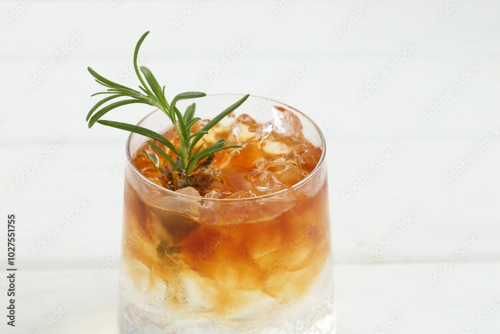 Refreshing espresso tonic drink with rosemary on white table, closeup Refreshing espresso tonic drink with rosemary on white table, closeup
