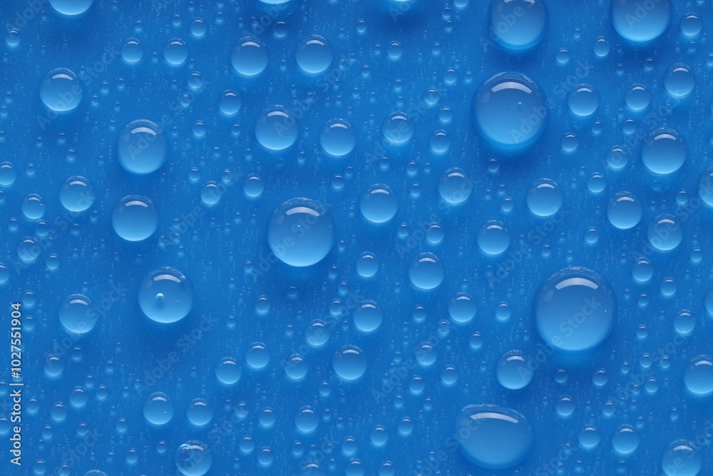 Water drops on blue background, top view Water drops on blue background, top view