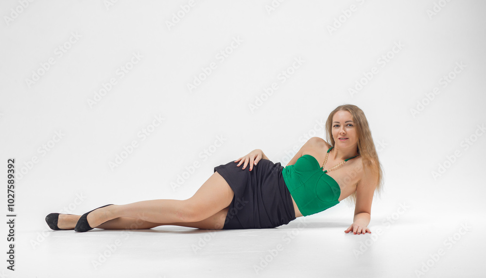 Girl in green top and black skirt poses for camera. She is wearing black heels and necklace. Beautiful sexy body. Girl in green top and black skirt poses for camera. She is wearing black heels and necklace. Beautiful sexy body.