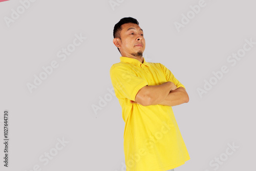 Adult Asian man standing confident with arms crossed showing happy expression

