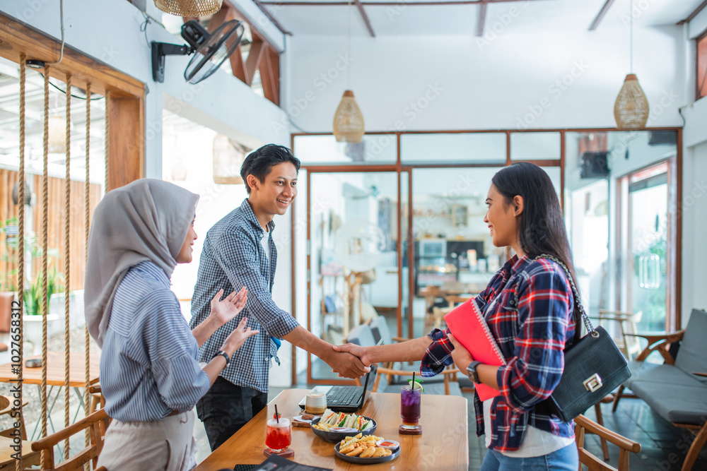 introduction of a man and woman by a Muslim woman in a coffee shop introduction of a man and woman by a Muslim woman in a coffee shop