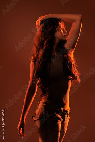 Young girl in red light, play of light and shadow