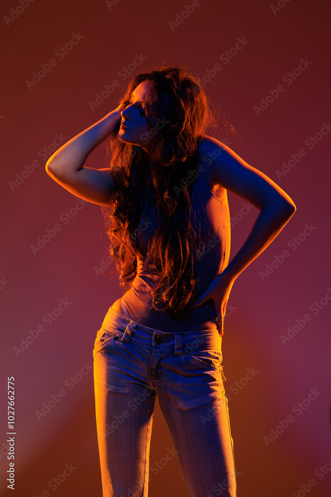 Young girl in red light, play of light and shadow Young girl in red light, play of light and shadow