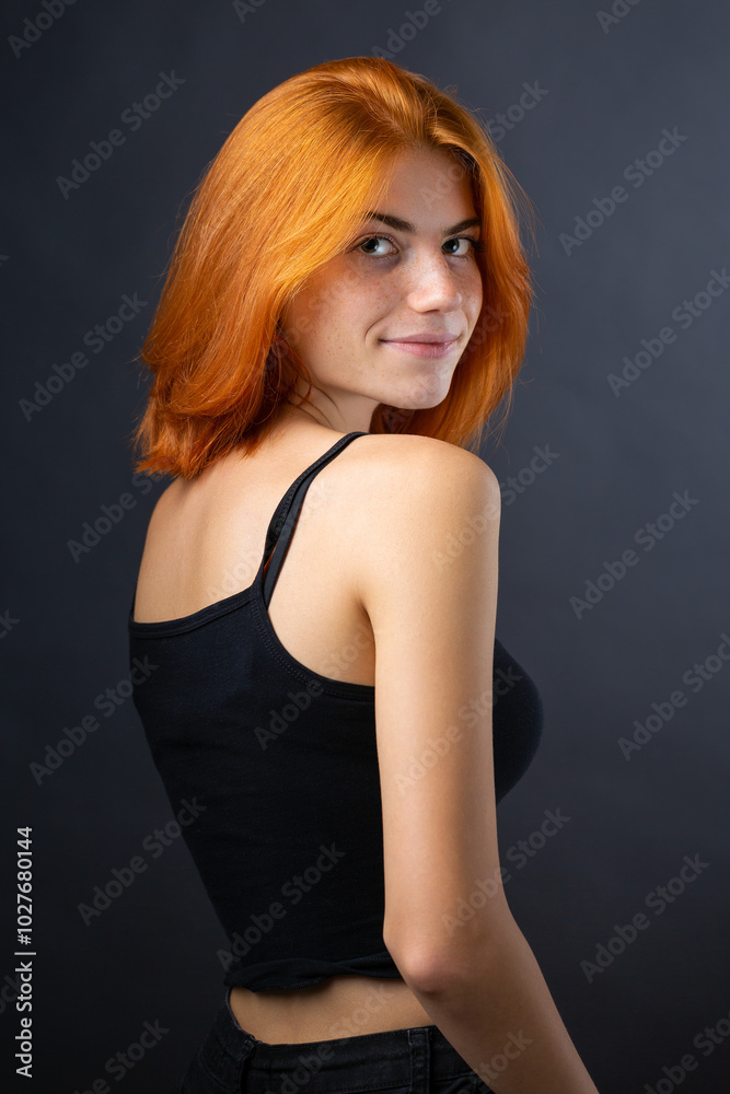Cute red-haired girl, studio portrait on a black background. Cute red-haired girl, studio portrait on a black background.