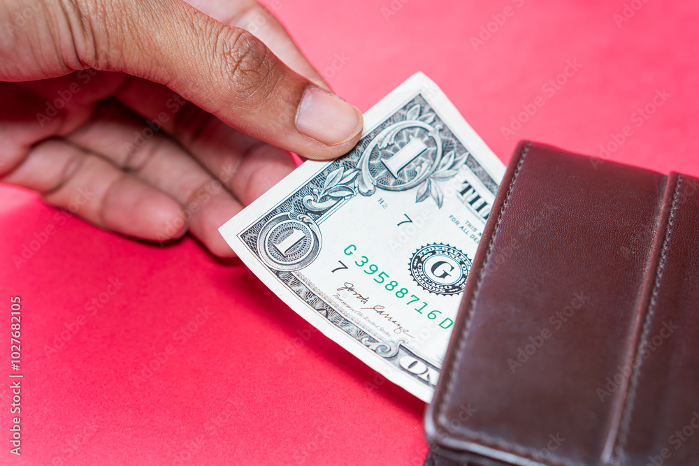One Dollar Bill in Leather Wallet on Red Background One Dollar Bill in Leather Wallet on Red Background