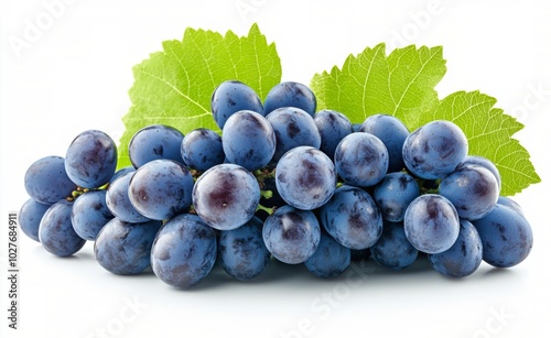 Fresh blue grapes arranged with green leaves on a light background ready for ...