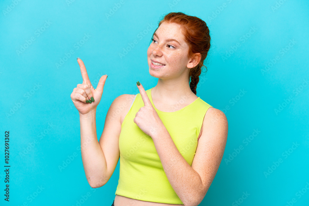 Young reddish woman isolated on blue background pointing with the index finger a great idea Young reddish woman isolated on blue background pointing with the index finger a great idea
