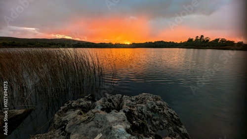 Obraz na płótnie Beautiful orange sunset lakeside landscape scenery at Ross lake, Roscahill, Galway, Ireland, nature background w salonie