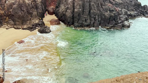 Turquoise water beautiful sea view with waves in a crashing flow. Waves crashing in rocks, sea green beautiful beach 