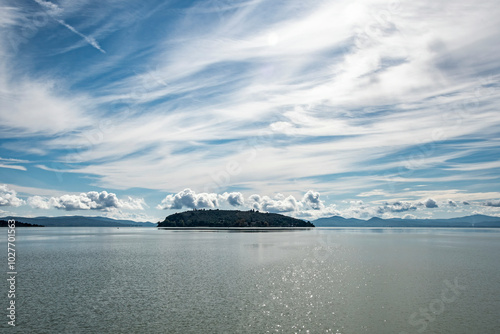 Scenic view of Isola Maggiore on Trasimeno lake against the sky, view from Tuoro sul Trasimeno, Umbria, Italy photo