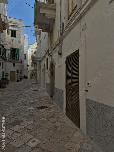 Elevation of buildings in the old city center. Narrow street with tenement houses in the old city. Bari, Italy.
