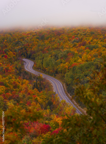 New England Scenic Fall Foliage Drive Road Curves Through Epic Forest. Beautiful Adirondacks New York Autumn Travel Tourism. Fog Clouds. No Cars photo