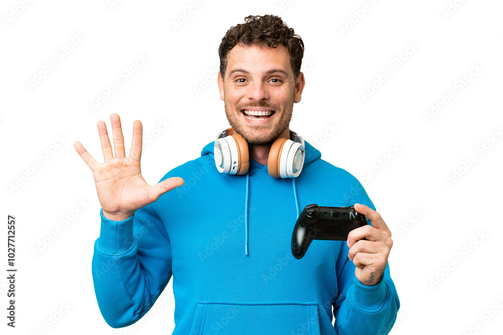 Brazilian man playing with a video game controller over isolated chroma key background counting five with fingers Brazilian man playing with a video game controller over isolated chroma key background counting five with fingers