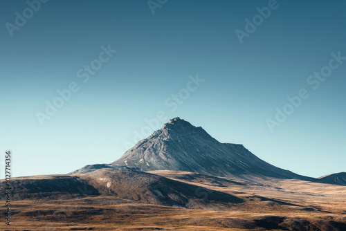 Lone mountain peak under a clear blue sky