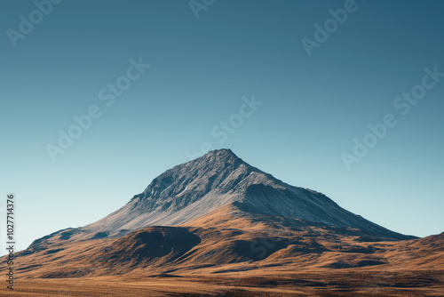 Lonely mountain peak under a calm blue sky